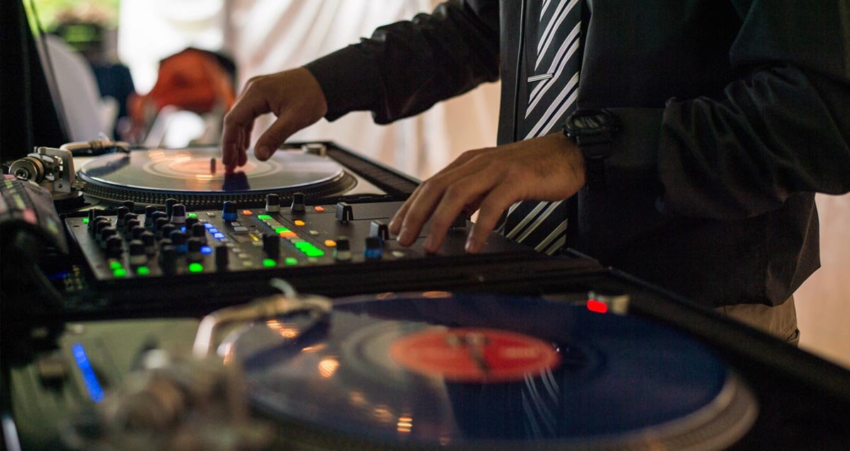 DJ setup at a party with vibrant lighting